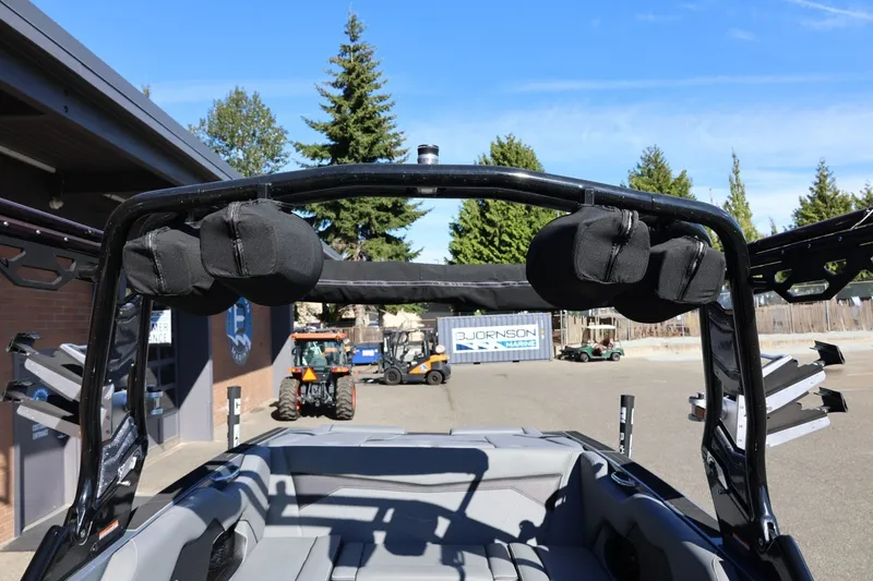 Slide: The Image of 2022 Supreme ZS252 boat interior with tower speakers and seating, parked outdoors. - 64