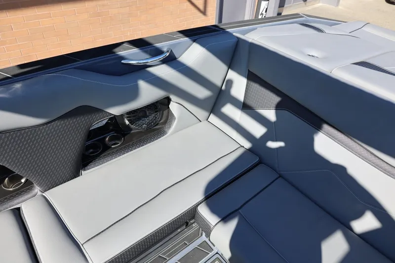 Slide: The Image of Interior seating of 2022 Supreme ZS252 boat, featuring sleek gray upholstery and cup holders. - 33