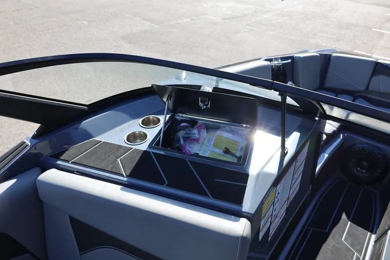Slide: The Image of 2022 Supreme ZS252 boat interior with open storage compartment and cup holders. - 52