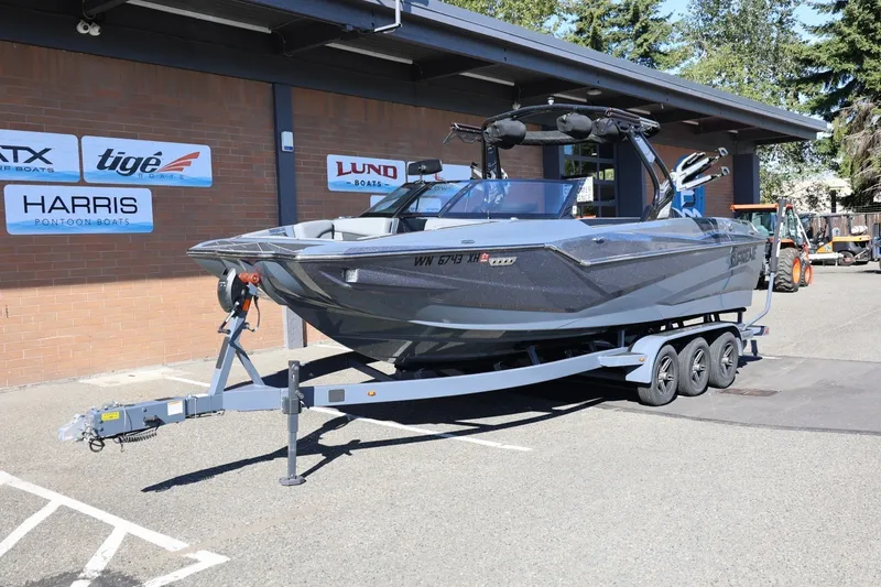 Slide: The Image of 2022 Supreme ZS252 boat on trailer outside dealership, showcasing sleek design. - 14