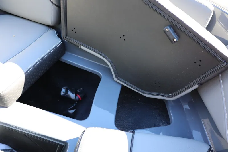 Slide: The Image of 2022 Supreme ZS252 boat interior storage compartment with open lid and seating. - 59