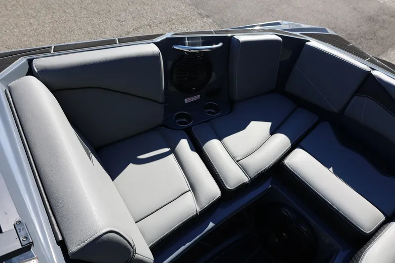 Slide: The Image of 2022 Supreme ZS252 boat interior with gray cushioned seating and cup holders. - 54