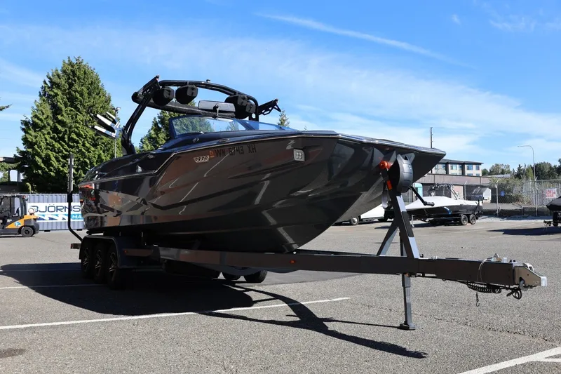 Slide: The Image of 2022 Supreme ZS252 boat on trailer in parking lot under clear blue sky. - 11