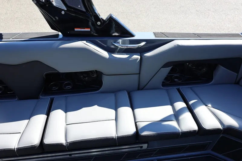 Slide: The Image of 2022 Supreme ZS252 boat interior with gray seating and cup holders. - 30
