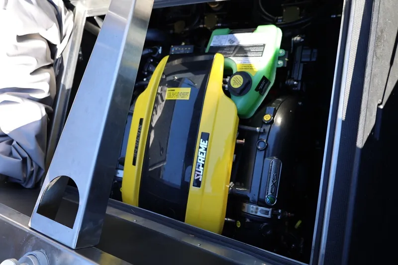 Slide: The Image of Engine compartment of 2022 Supreme ZS252 boat, featuring a yellow and black engine. - 23