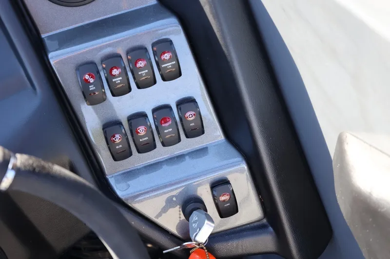 Slide: The Image of Control panel of a 2022 Supreme ZS252 boat with labeled switches and ignition key. - 48
