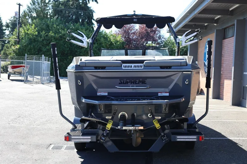Slide: The Image of 2022 Supreme ZS252 boat rear view in a parking area, showcasing sleek design and features. - 5