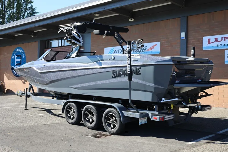 Slide: The Image of 2022 Supreme ZS252 boat on trailer, parked outside a marine dealership. - 4