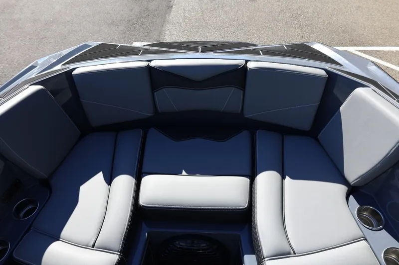 Slide: The Image of 2022 Supreme ZS252 boat interior with gray cushioned seating and cup holders. - 56