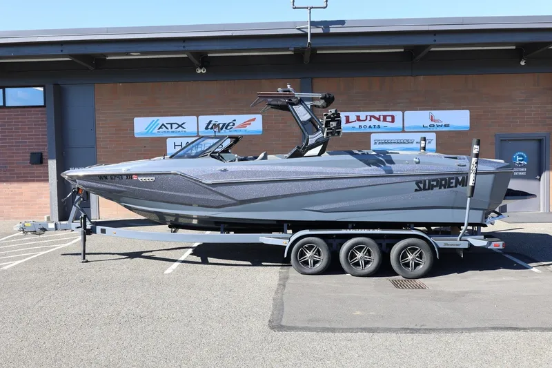 The Image of 2022 Supreme ZS252 boat on trailer, parked outside dealership. - 1