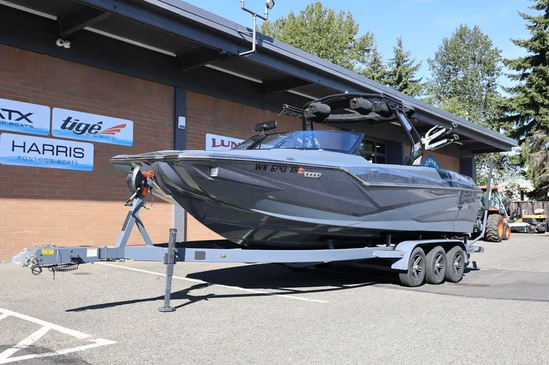 Slide: The Image of 2022 Supreme ZS252 boat on trailer, parked outside dealership with signage. - 15