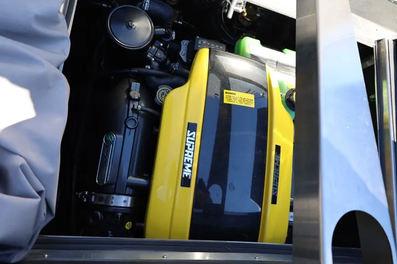 Slide: The Image of 2022 Supreme ZS252 engine compartment with yellow cover and visible components. - 24