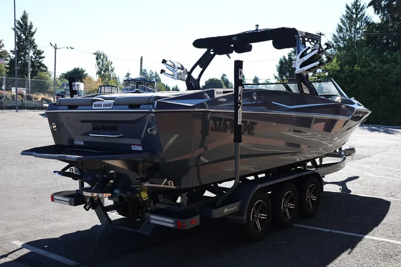 Slide: The Image of 2022 Supreme ZS252 boat on trailer, parked outdoors, showcasing sleek design and modern features. - 7