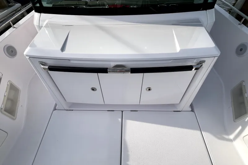 Slide: The Image of 2023 Axopar 37 XC Cross Cabin interior with sleek white cabinetry and modern design. - 34