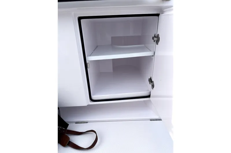 Slide: The Image of Open storage compartment in 2023 Axopar 37 XC Cross Cabin boat. - 38