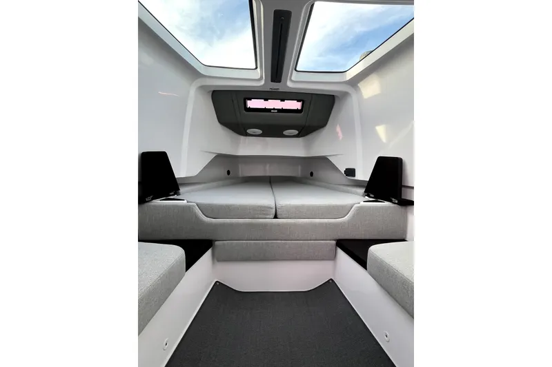 Slide: The Image of 2023 Axopar 37 XC Cross Cabin interior with skylights and modern seating. - 22