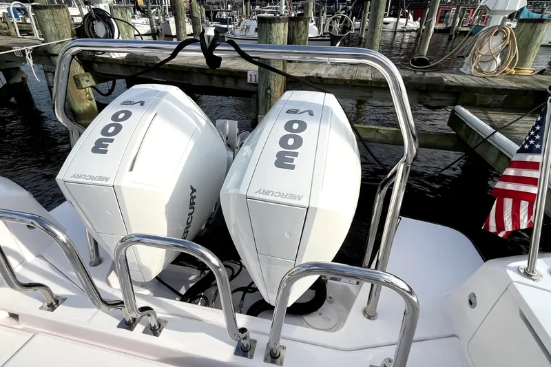 Slide: The Image of Twin Mercury 300 engines on a 2023 Axopar 37 XC Cross Cabin boat at a marina. - 39
