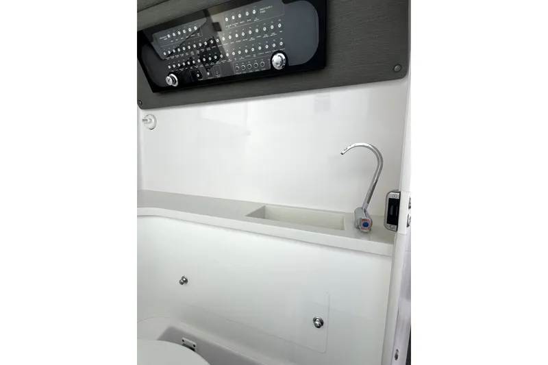 Slide: The Image of 2023 Axopar 37 XC Cross Cabin interior with control panel and sink. - 26