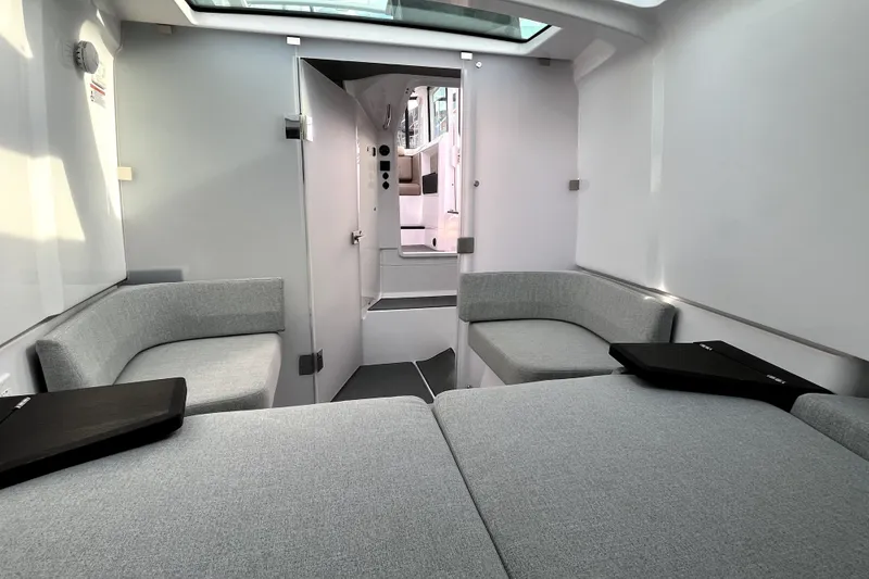Slide: The Image of Interior of 2023 Axopar 37 XC Cross Cabin, featuring modern seating and sleek design. - 23