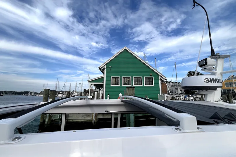 Slide: The Image of 2023 Axopar 37 XC Cross Cabin docked near a green building, marina view. - 41