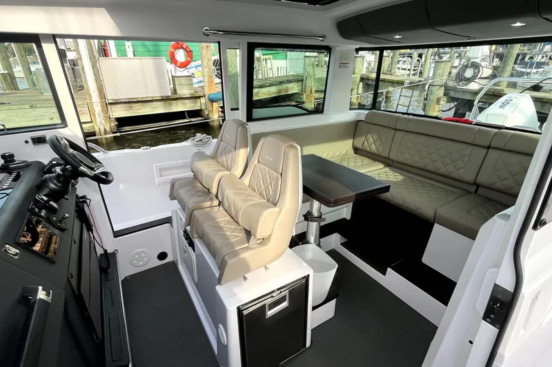 Slide: The Image of Interior of 2023 Axopar 37 XC Cross Cabin with seating and table. - 10