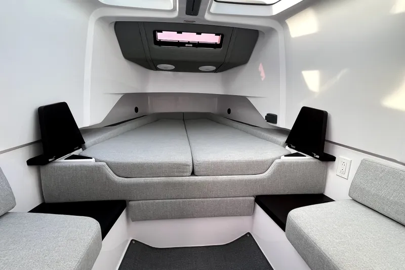 Slide: The Image of 2023 Axopar 37 XC Cross Cabin interior with modern gray seating and sleek design. - 21