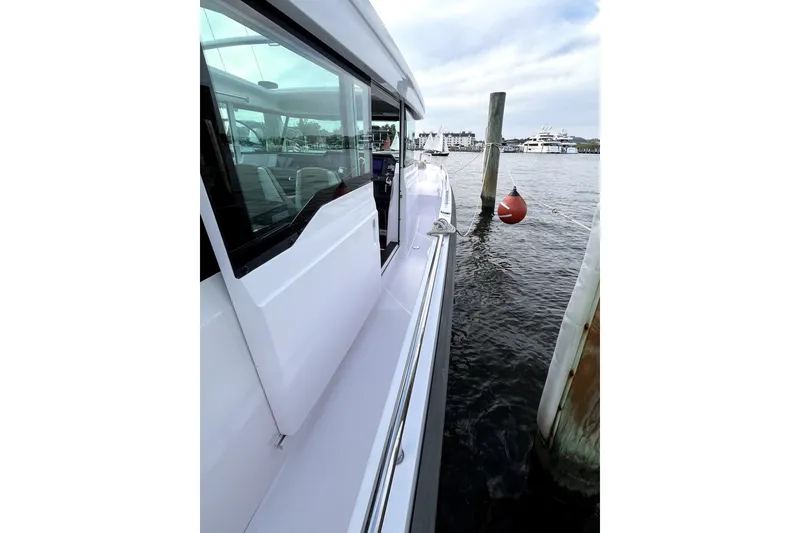 Slide: The Image of 2023 Axopar 37 XC Cross Cabin docked, showcasing sleek design and modern features. - 8