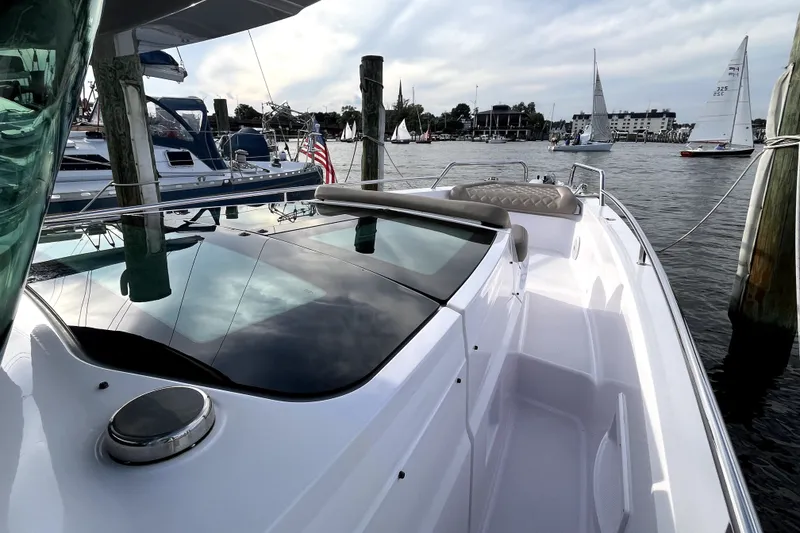 Slide: The Image of 2023 Axopar 37 XC Cross Cabin docked, showcasing sleek design and waterfront view. - 27