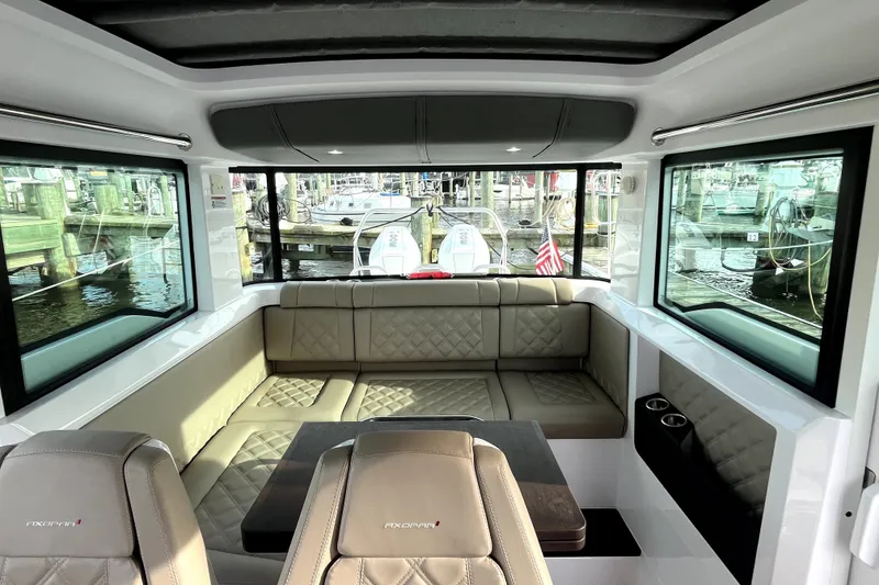 Slide: The Image of Interior of 2023 Axopar 37 XC Cross Cabin with luxurious seating and panoramic windows. - 12