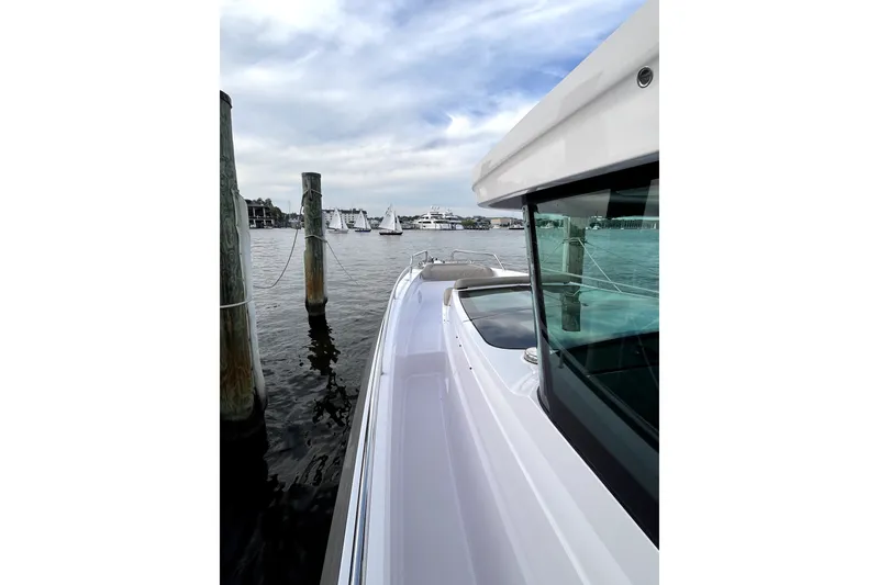 Slide: The Image of 2023 Axopar 37 XC Cross Cabin docked, showcasing sleek design and waterfront view. - 42