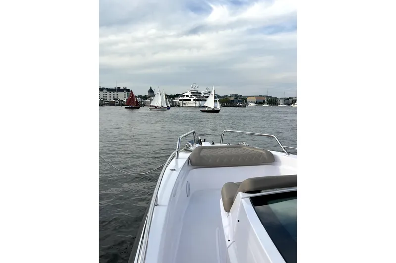 Slide: The Image of 2023 Axopar 37 XC Cross Cabin on water with sailboats in background. - 31