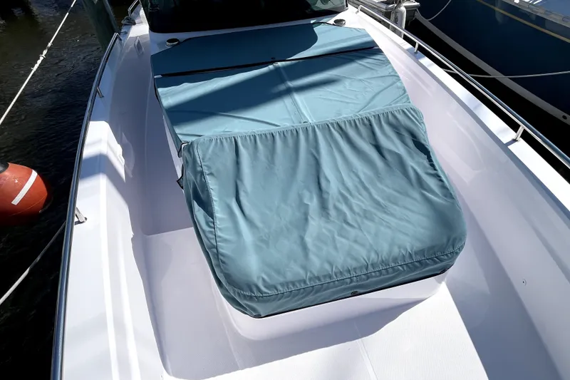 Slide: The Image of 2023 Axopar 37 XC Cross Cabin with blue protective cover on deck. - 47