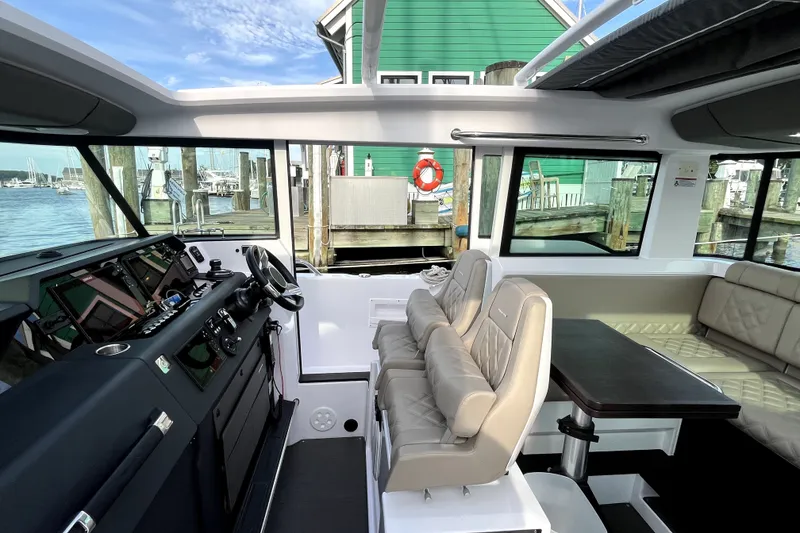 Slide: The Image of Interior of 2023 Axopar 37 XC Cross Cabin boat with modern seating and helm. - 11