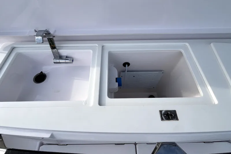 Slide: The Image of 2023 Axopar 37 XC Cross Cabin sink and storage compartment detail. - 36