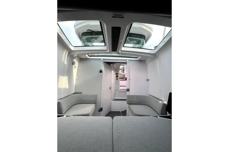 Slide: The Image of Interior of 2023 Axopar 37 XC Cross Cabin with skylights and modern seating. - 24