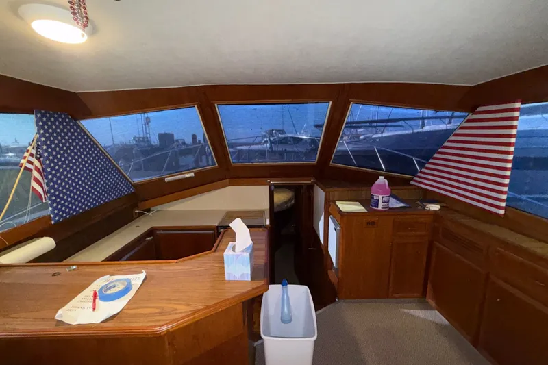 Slide: The Image of Interior of 1984 Egg Harbor 40 Sedan yacht with wooden cabinetry and American flag decor. - 15