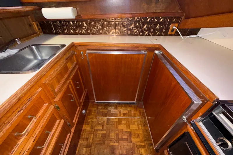 Slide: The Image of 1984 Egg Harbor 40 Sedan kitchen with wood cabinetry and stainless steel sink. - 21