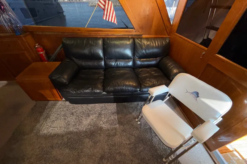 Slide: The Image of Interior of 1984 Egg Harbor 40 Sedan with black leather sofa and white chair. - 14