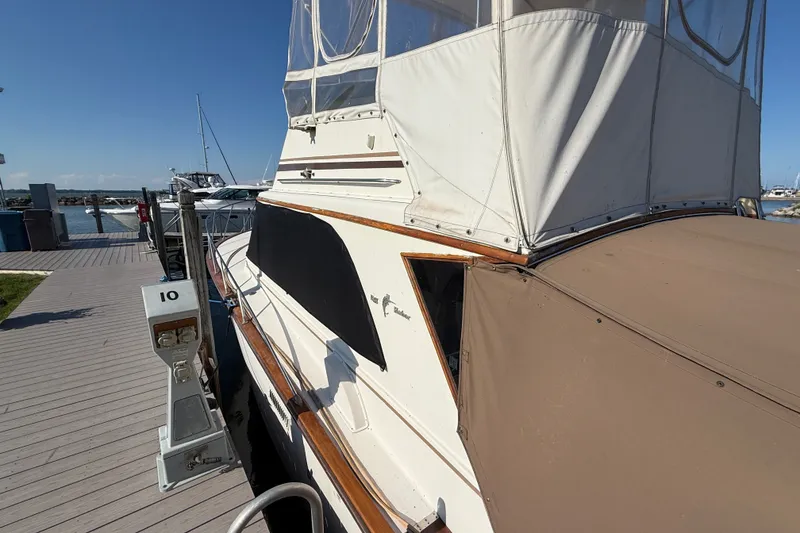 Slide: The Image of 1984 Egg Harbor 40 Sedan yacht docked at marina under clear blue sky. - 7
