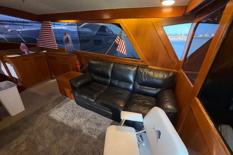 Slide: The Image of Interior of 1984 Egg Harbor 40 Sedan with leather sofa and nautical decor. - 13