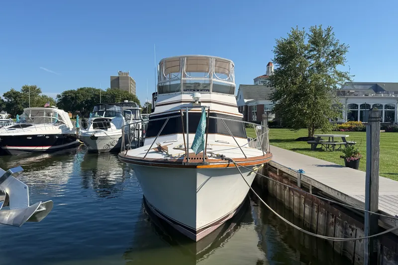 Slide: The Image of 1984 Egg Harbor 40 Sedan yacht docked at marina, surrounded by other boats. - 2