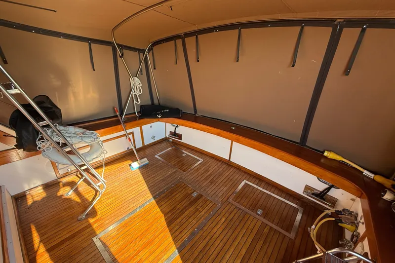 Slide: The Image of 1984 Egg Harbor 40 Sedan boat interior with wooden flooring and metal railings. - 9