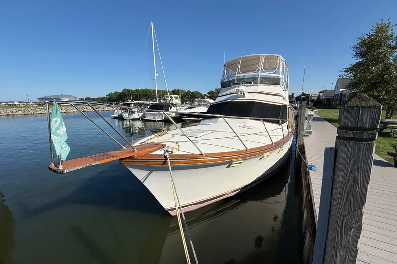 Slide: The Image of 1984 Egg Harbor 40 Sedan yacht docked at marina under clear blue sky. - 1