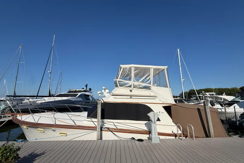 Slide: The Image of 1984 Egg Harbor 40 Sedan yacht docked at marina under clear blue sky. - 3