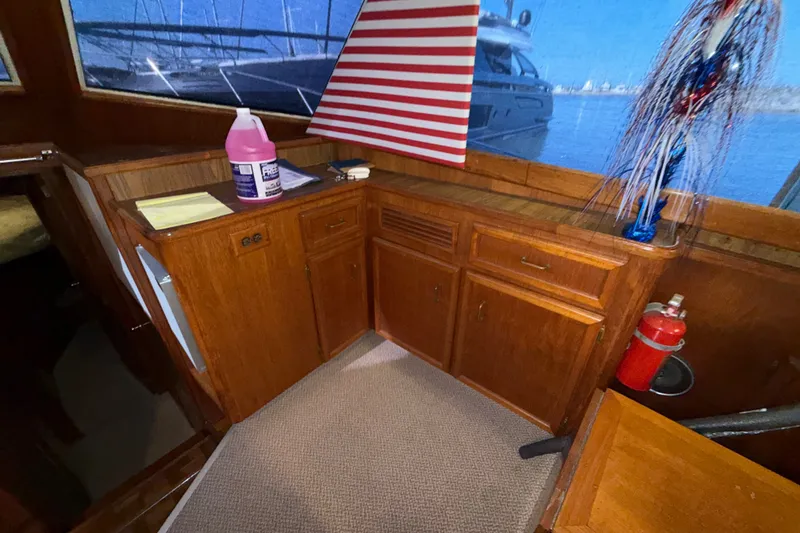 Slide: The Image of 1984 Egg Harbor 40 Sedan interior with wooden cabinetry and nautical decor. - 18