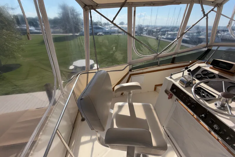 Slide: The Image of Cockpit of 1984 Egg Harbor 40 Sedan with steering wheel and captain's chair. - 29