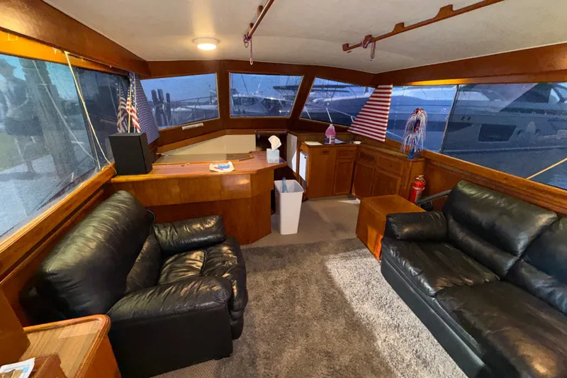 Slide: The Image of Interior of a 1984 Egg Harbor 40 Sedan yacht with leather seating and wooden cabinetry. - 12