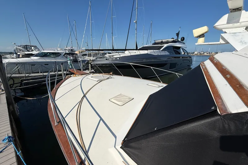Slide: The Image of 1984 Egg Harbor 40 Sedan docked among other boats in a marina. - 8