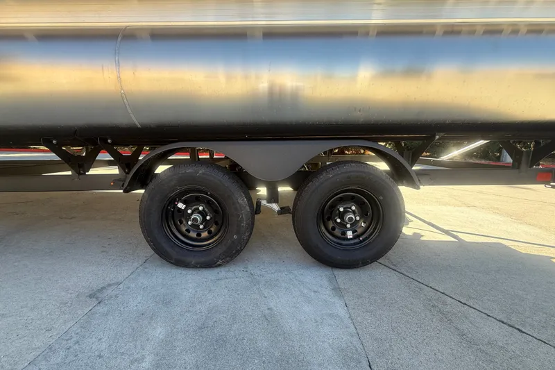 Slide: The Image of 2027 Sun Tracker SportFish 20 DLX trailer wheels on concrete surface. - 55