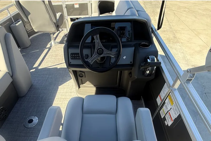 Slide: The Image of Interior view of 2027 Sun Tracker SportFish 20 DLX boat cockpit with steering wheel. - 23
